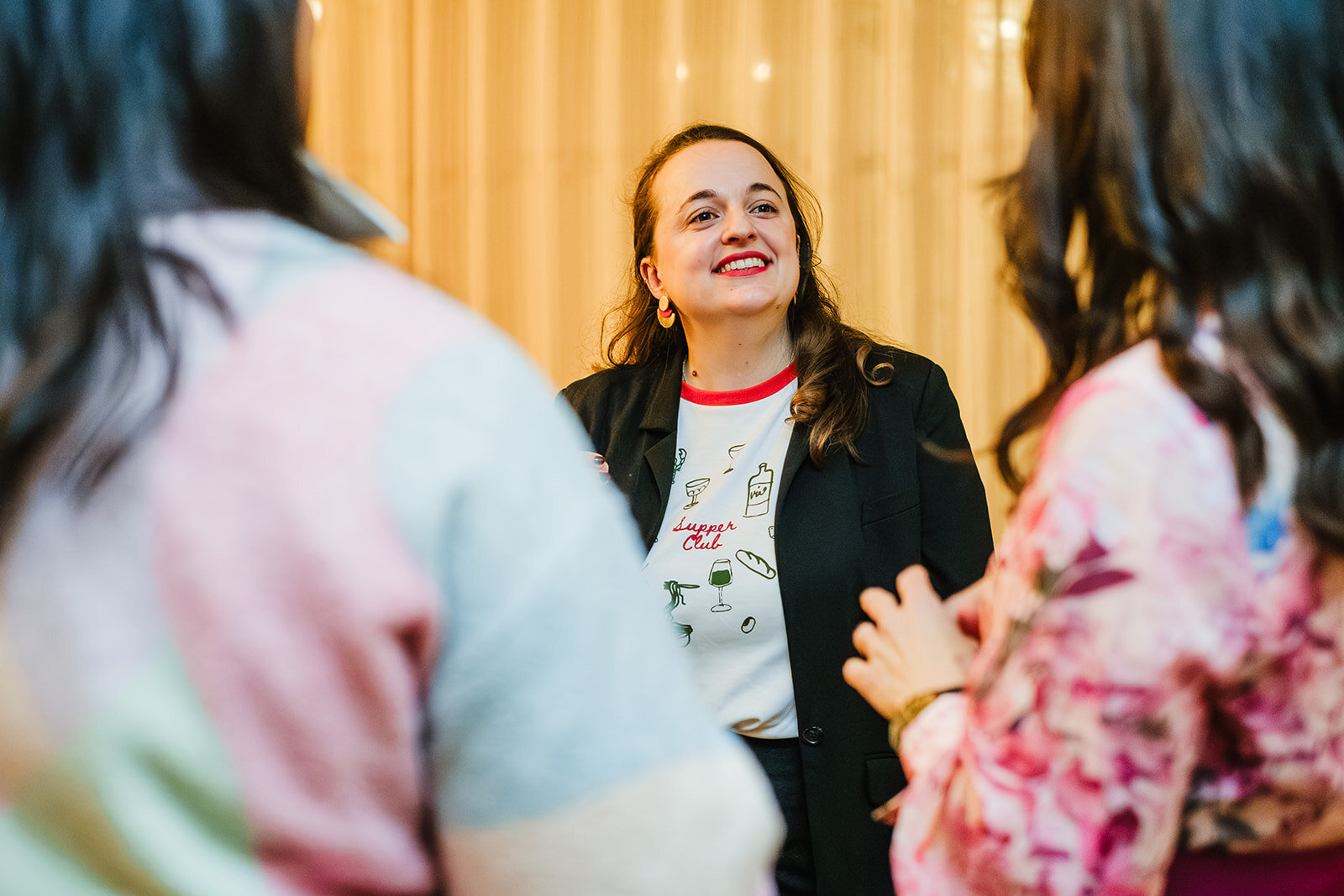 Pauline, founder of WeTalk, talking with guests at a supper club
